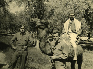 Donald S. Frederick encounters a camel in a North African oasis, 1942.