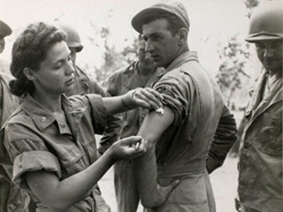 United States Army Nurse Corps Lieutenant Ernestine Koranda of Wadena, Minnesota giving injection to Sergeant James Visaki of Burlington, New Jersey in Queensland, Australia. Loc. no. E448.24 p10