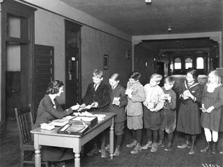 Group of children at Harriet School depositing money in their savings accounts, 1920. Loc. no. I.129.10