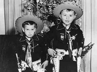 Mike and Harry Sieben dressed in cowboy outfits, standing in front of Christmas tree, 1951. Loc. no. GV8.1 p31