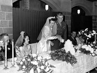 Wedding in the family of Mr. and Mrs. H. Lovas; bride and groom cutting cake, groom in uniform, 1944. Loc. no. Collection I.366.198 