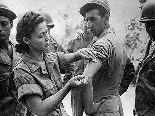 US Army Nurse Corps Lt.Ernestine Koranda of Wadena, MN giving injection to St. James Visaki, Queensland, Australia, 1943. Loc. no. E448.24 p10