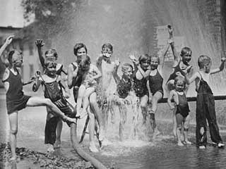 Children playing in water spray from fire hose, ca. 1930s. Loc. no.
QC1.3 p9 