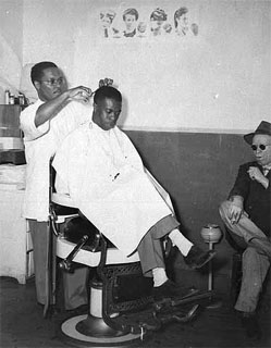 Photo: Sylvester Young, barber in shop owned by Walter Battle, Battle's Barber Shop, Sixth and Lyndale, Minneapolis, 1945-1950.