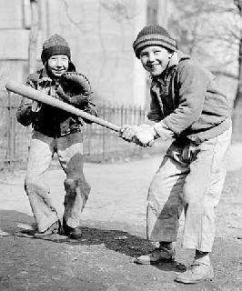 Photo: Young boy up to bat as catcher awaits the pitch, 1937.