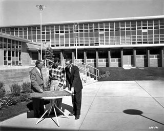 Men looking at blueprints, outside Bloomington High School, Bloomington, 1958.