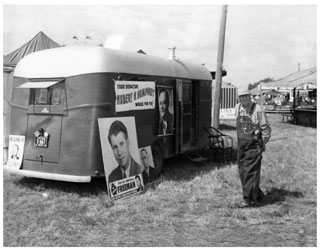 Photo: Trailer posted with campaign signs for Orville Freeman and Hubert H. Humphrey; a small sign for Val Bjornson is on the rear bumper, 1954.