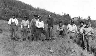 Indian Civilian Conservation Corps crew on stockade site at end of first day's work, Grand Portage, 1937.
