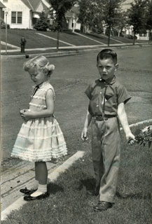 Photo: Danny Cousins, waiting for the school bus on the first day of school, 1958.