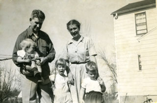 The Day family standing near their new home in Richfield, ca. 1949.