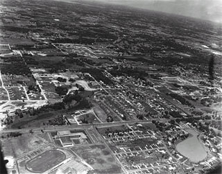 Photo: Edina, looking Northwest (Edina High School in lower left foreground and Lake Harvey (Highway 100) in lower right), Aerial, 1955.