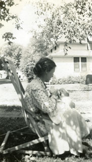 Emily Day feeding her youngest son, John, in the family's yard in Richfield, 1951.