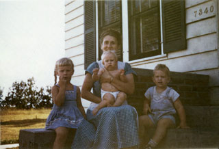 Photo: Emily Day, sitting on steps of Richfield home with her children, ca. 1949. 