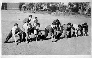 Boys playing football at Webster School, St. Paul, 1938.
