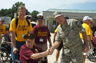 Ken Fritz (seated) is greeted at the WWII Memorial by a Chief Master Sergeant in the US Air Force.