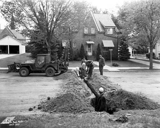 Photo: Working on gas line in a street in Rosemount, 1957.