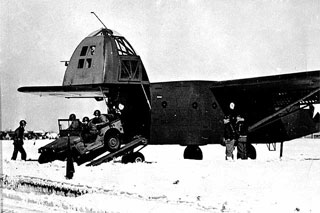 Photo: A military jeep is unloaded from a CG-4A glider in a training exercise.