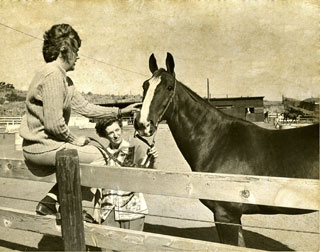 Dr. Bee Hanlon (holding Caesar) with Dr. Christine Gibbs, Radiologist at the University of Bristol, England at Terra Verde Stables in Montana, 1973.  