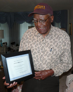 Matthew Little, holding Minneapolis African American Professional Firefighters Association certificate, 2008.