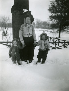 Marian Maxson and daughters playing in the snow, 1944.