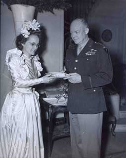 Pearlie Hargrave McKeogh offers General Eisenhower some wedding cake at the reception hosted by the General.