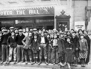 Children standing outside a theater, 1930. 