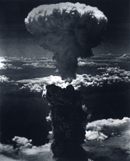 The mushroom cloud towering over Nagasaki, Japan following the dropping of the atomic bomb, August 9, 1945.