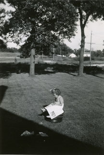 Photo: Mary Maxson, reading a book in the family's spacious backyard in Richfield, 1943.