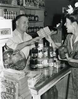 Photo: Woman using ration stamps at a grocery store, 1945.