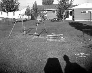 Swingset and sandbox in backyard of house in Richfield, 1958.