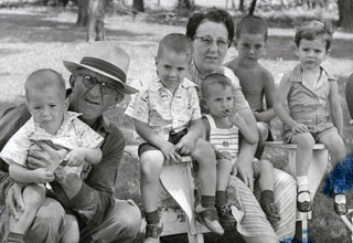 Photo: Randy (left) and Ricky (3rd left) with their Grandma and Grandpa Staudt at their farm near Marble Rock, IA, 1958.