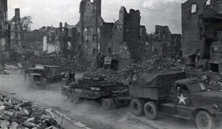 Lt. Steinhauser's tank transporters going through Achen, Germany, 1945.