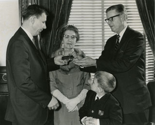 Photo: Governor Harold LeVander, presenting the All-America Goalpost Trophy to the Pearson family, 1967.