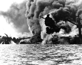 The USS Arizona, sunk and burning in Pearl Harbor, December 7, 1941.