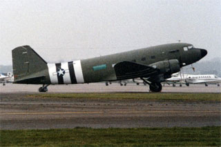 Photo: Douglas C-47 Skytrain painted with invasion stripes.